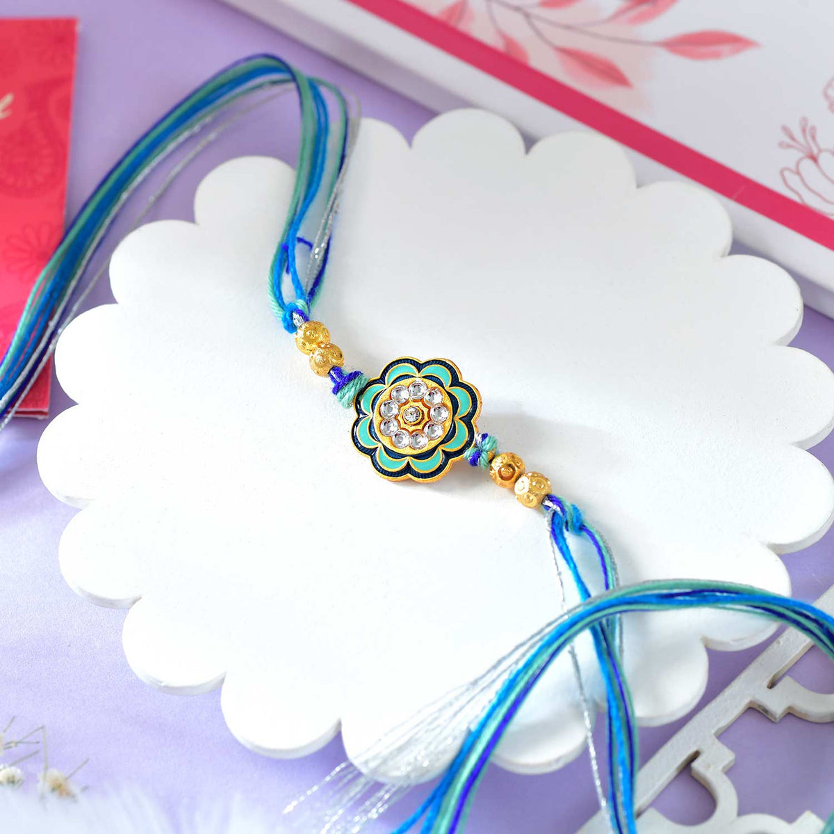 Floral Shaped Bhai Rakhi With Blue Thread