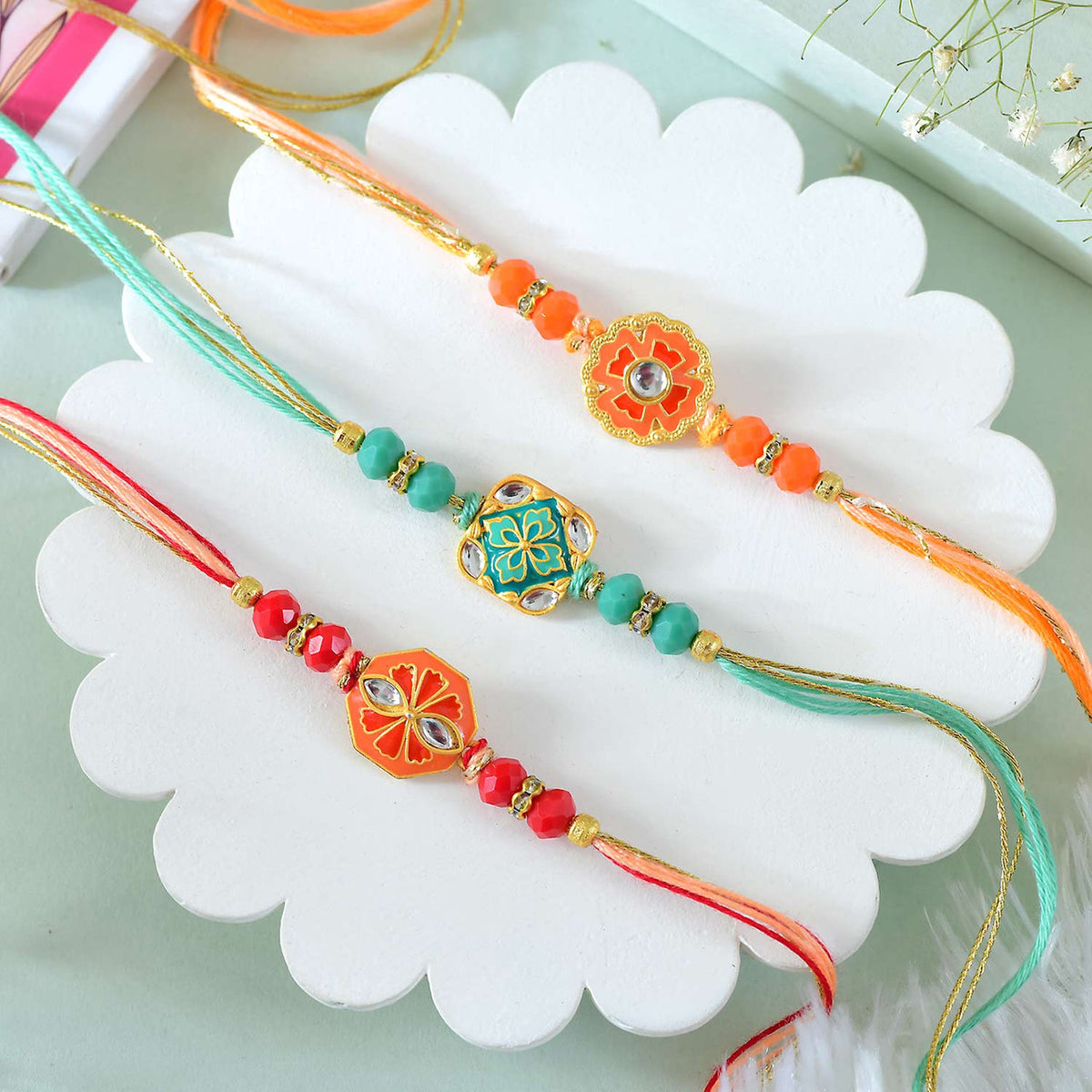 Set of 3 Floral Shape Rakhi With Besan Laddoo