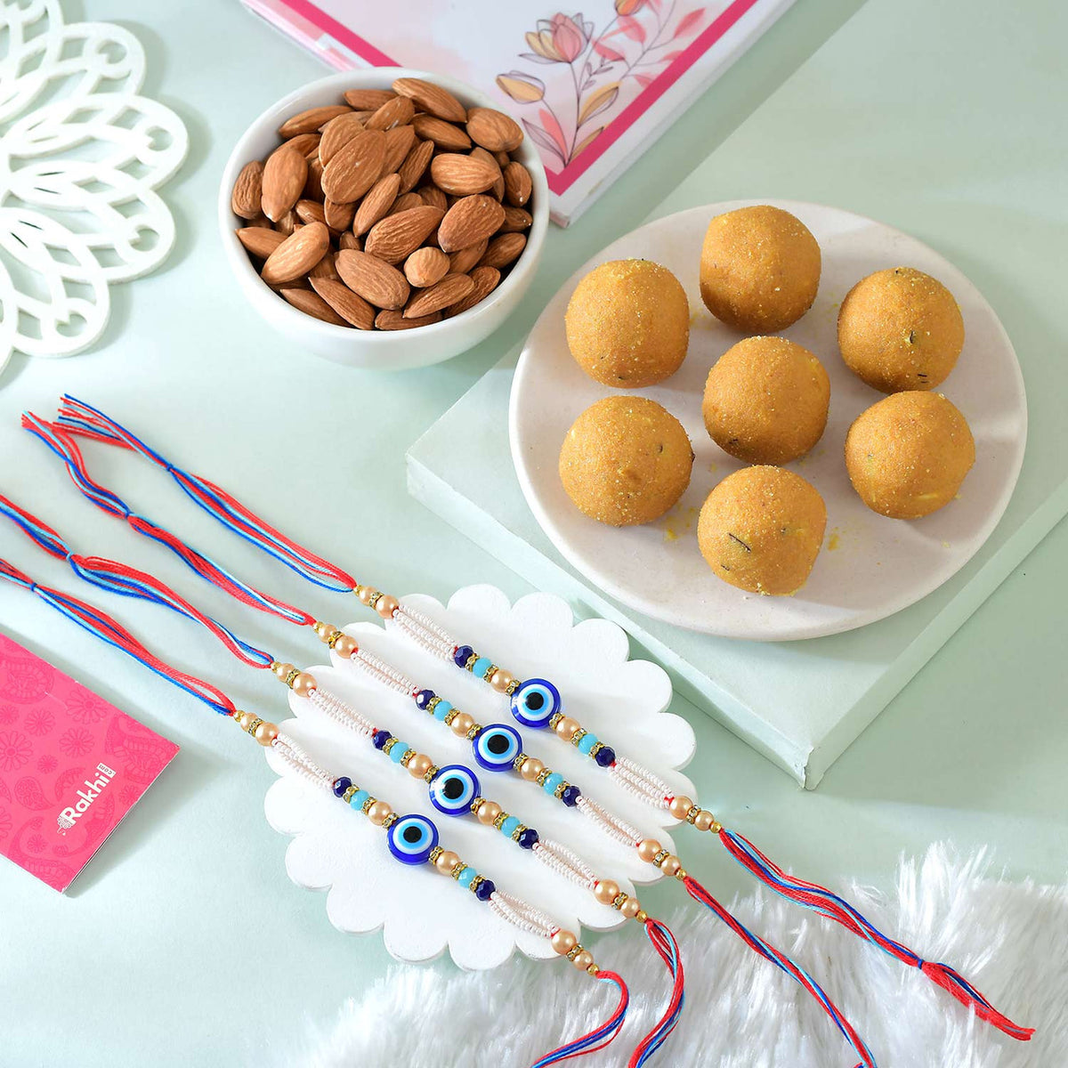 Set of 4 Evil Eye Rakhi With Besan Laddoo & Almond