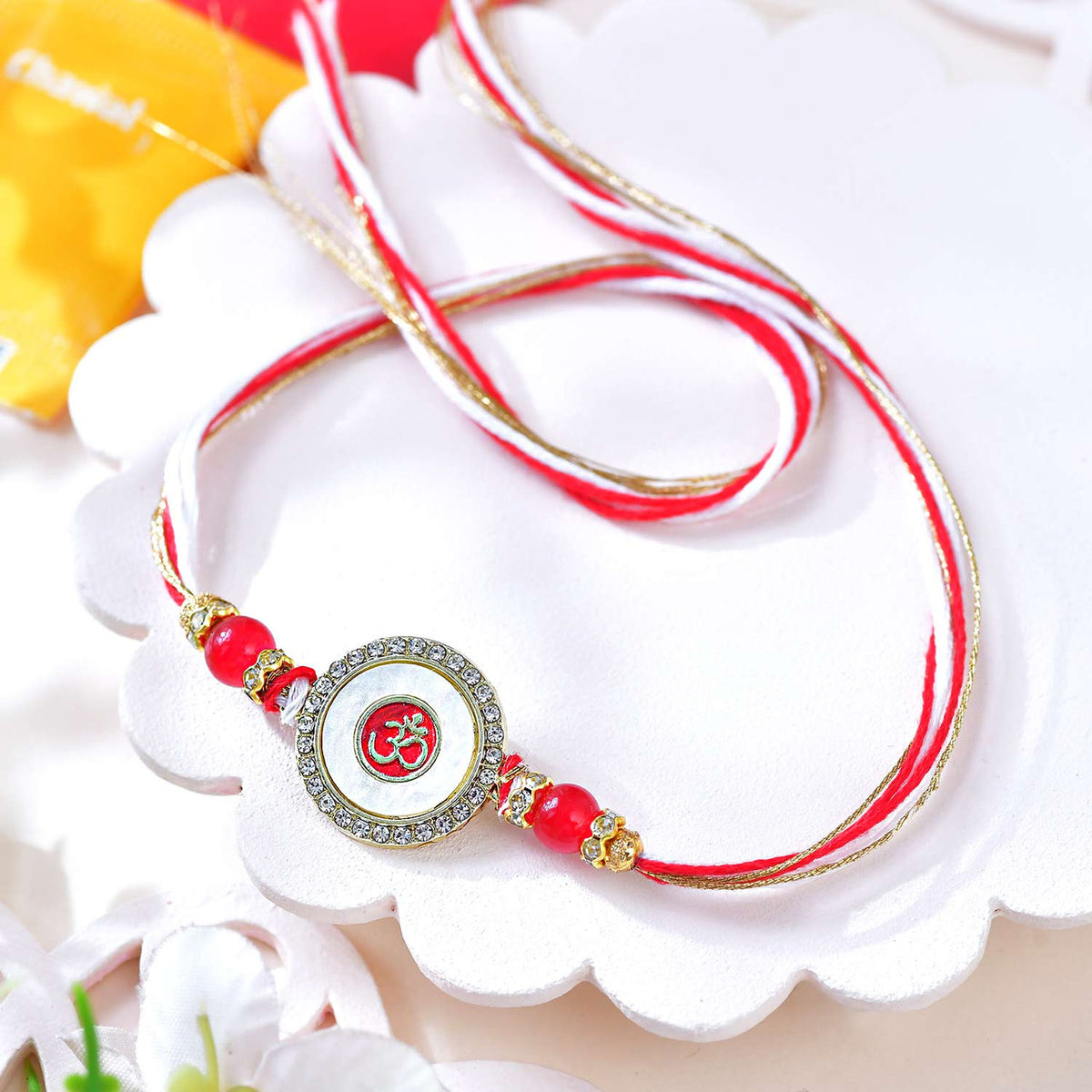 Elegant Om Circular Rakhi with Red and White Threads